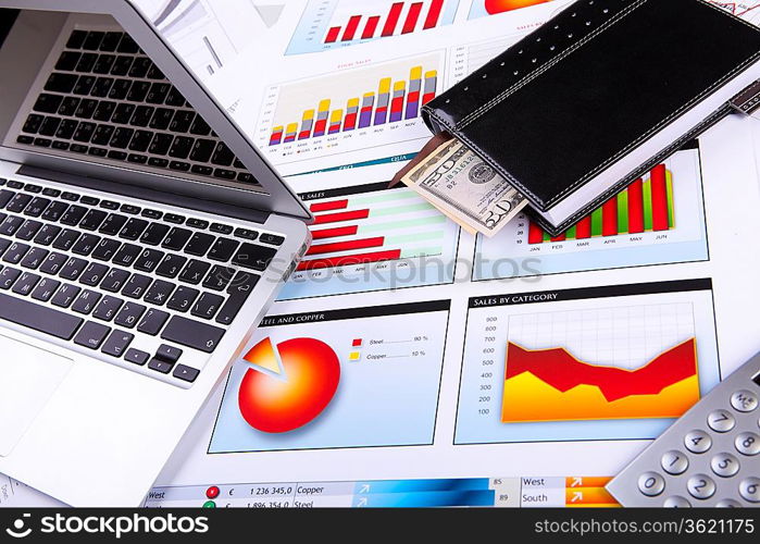 Financial paper charts and graphs on the table