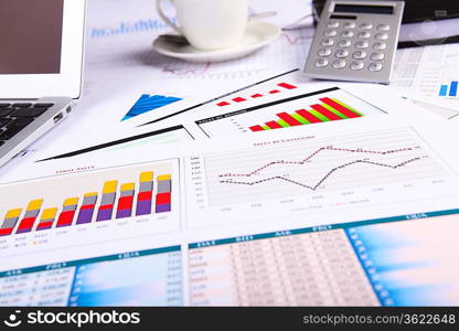 Financial paper charts and graphs on the table