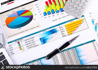 Financial paper charts and graphs on the table