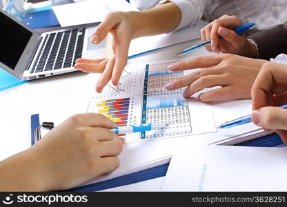 Financial paper charts and graphs on the table