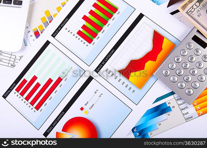 Financial paper charts and graphs on the table