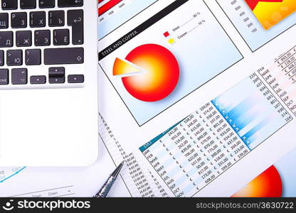 Financial paper charts and graphs on the table