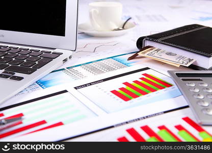 Financial paper charts and graphs on the table