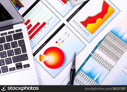 Financial paper charts and graphs on the table