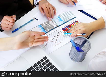 Financial paper charts and graphs on the table