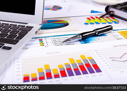 Financial paper charts and graphs on the table