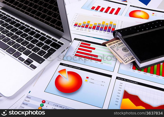 Financial paper charts and graphs on the table