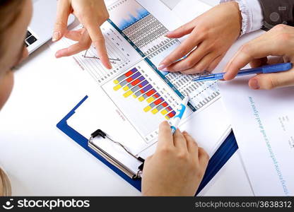 Financial paper charts and graphs on the table