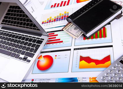 Financial paper charts and graphs on the table