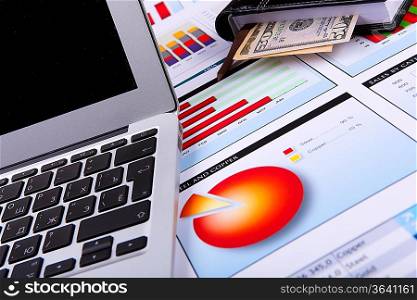 Financial paper charts and graphs on the table