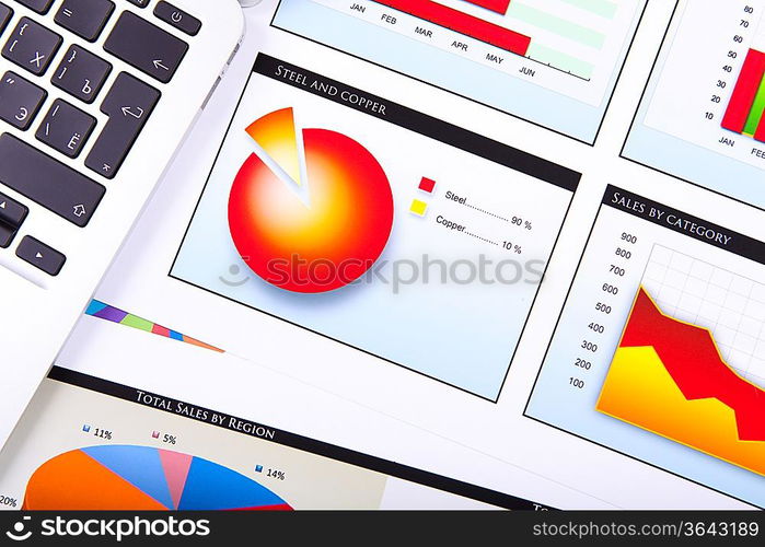 Financial paper charts and graphs on the table