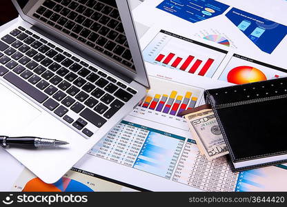 Financial paper charts and graphs on the table