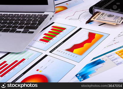 Financial paper charts and graphs on the table