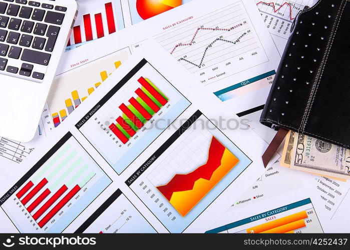 Financial paper charts and graphs on the table