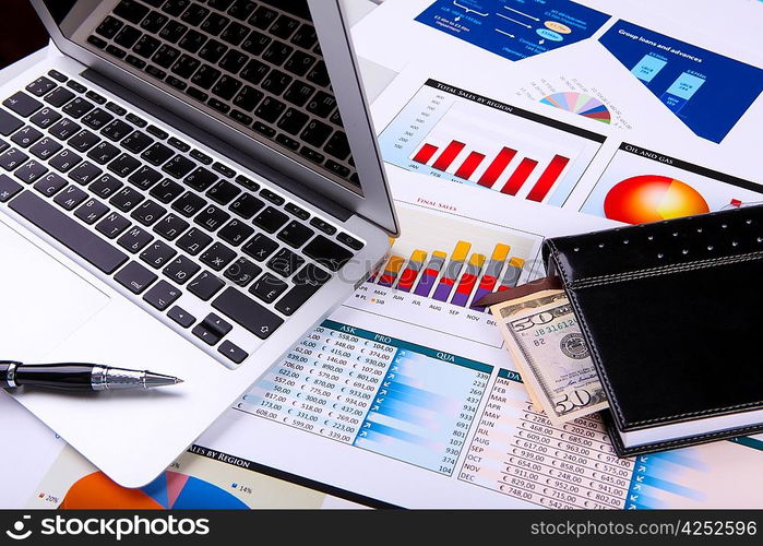 Financial paper charts and graphs on the table