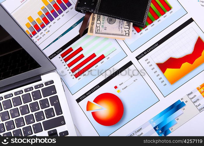 Financial paper charts and graphs on the table