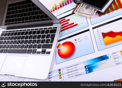 Financial paper charts and graphs on the table