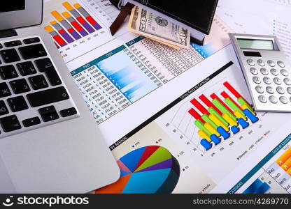 Financial paper charts and graphs on the table