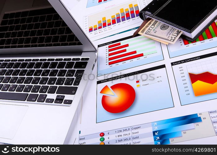 Financial paper charts and graphs on the table