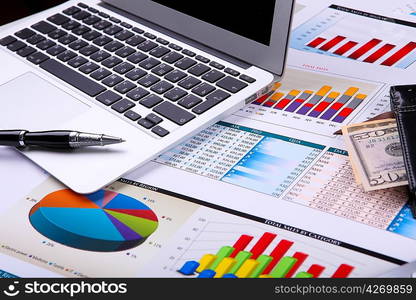 Financial paper charts and graphs on the table