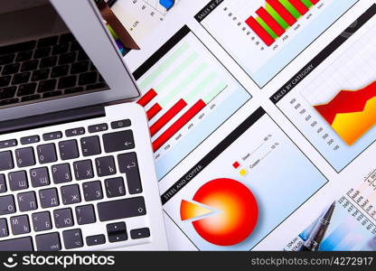 Financial paper charts and graphs on the table