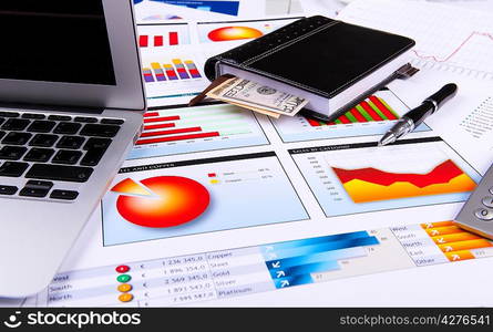 Financial paper charts and graphs on the table