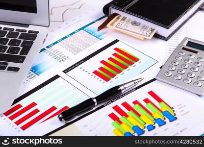 Financial paper charts and graphs on the table