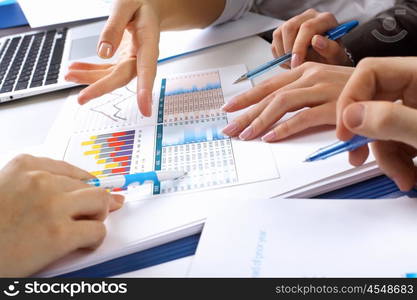 Financial paper charts and graphs on the table