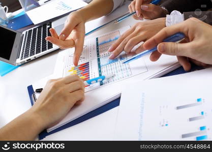 Financial paper charts and graphs on the table