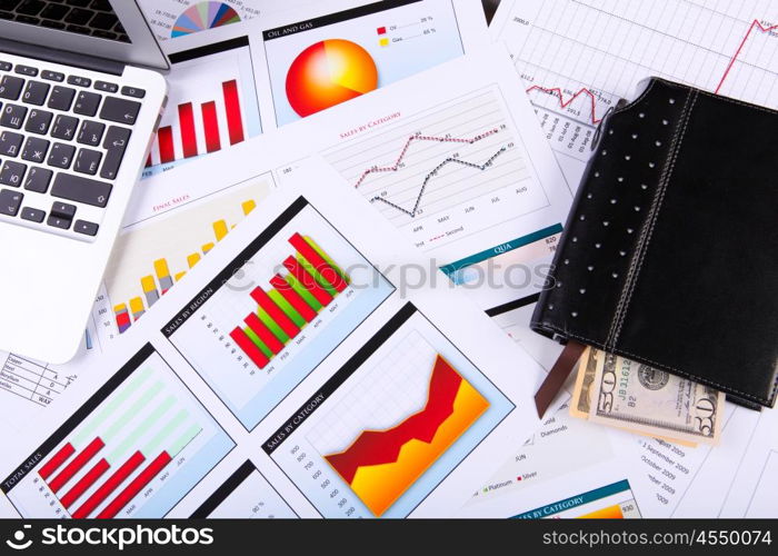 Financial paper charts and graphs on the table