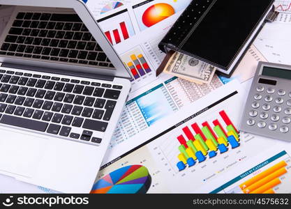 Financial paper charts and graphs on the table