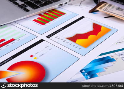 Financial paper charts and graphs on the table