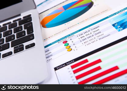 Financial paper charts and graphs on the table