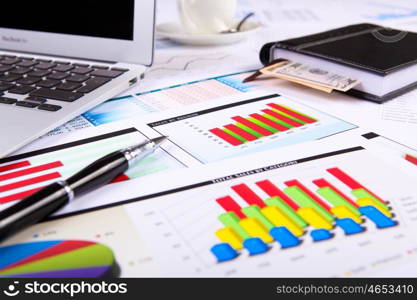 Financial paper charts and graphs on the table