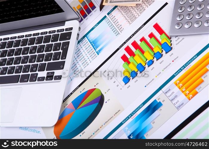 Financial paper charts and graphs on the table