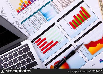 Financial paper charts and graphs on the table