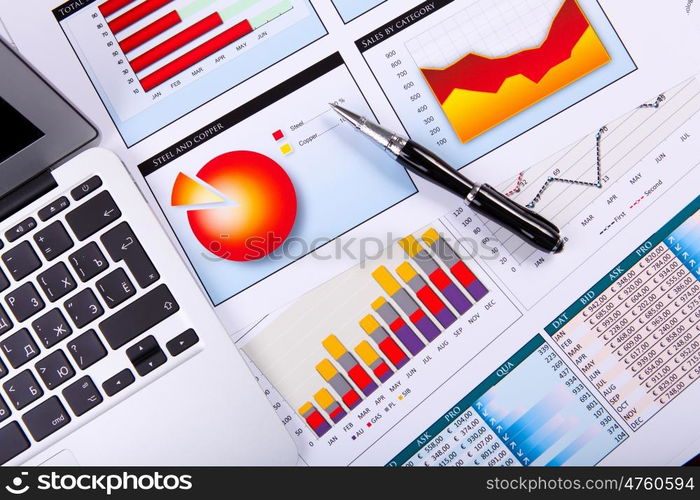 Financial paper charts and graphs on the table