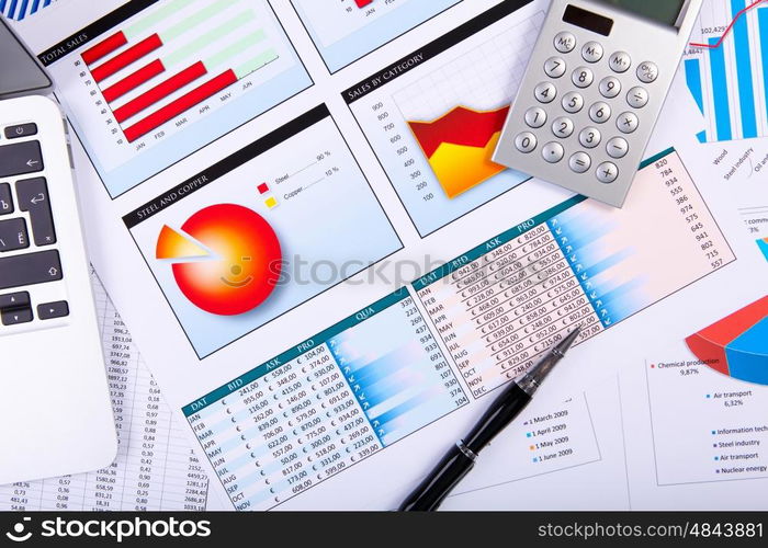 Financial paper charts and graphs on the table