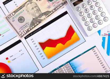 Financial paper charts and graphs on the table