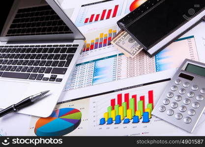 Financial paper charts and graphs on the table