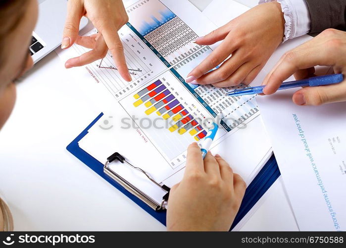 Financial paper charts and graphs on the table