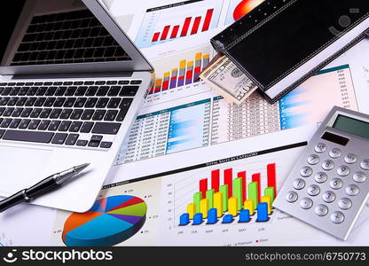 Financial paper charts and graphs on the table