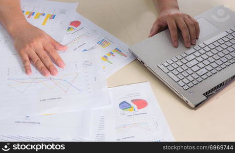 Financial paper charts, graphs and notebook on the table