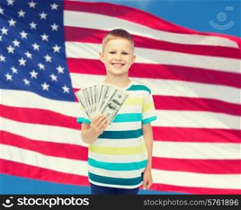financial, planning, childhood and educational concept - smiling boy holding dollar cash money in his hand over american flag background