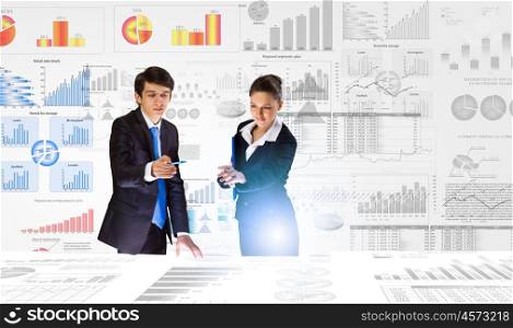 Financial report. Young businessman and businesswoman discussing financial report
