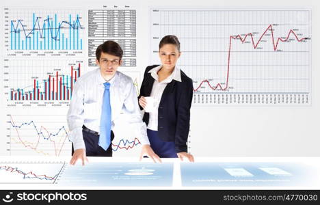 Financial report. Young businessman and businesswoman discussing financial report