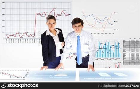 Financial report. Young businessman and businesswoman discussing financial report