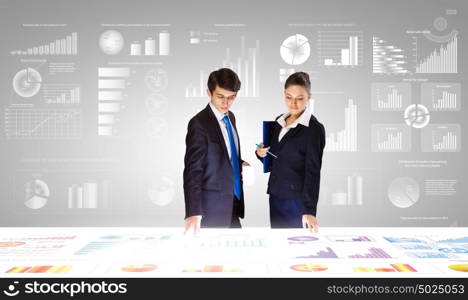 Financial report. Young businessman and businesswoman discussing financial report