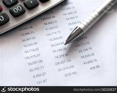 Financial spreadsheet data with pen and calculator.Accounting financial concept.