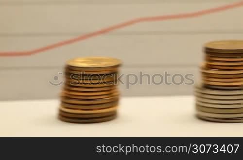 Financial success concept - graph with coins stacks